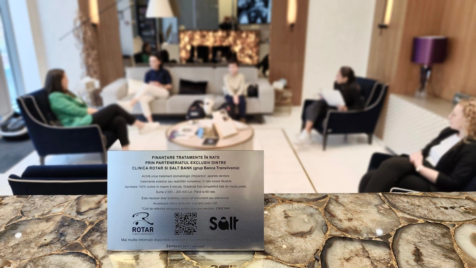 Clinica Rotar financing information plaque with QR code displayed on luxury clinic table in Cluj-Napoca