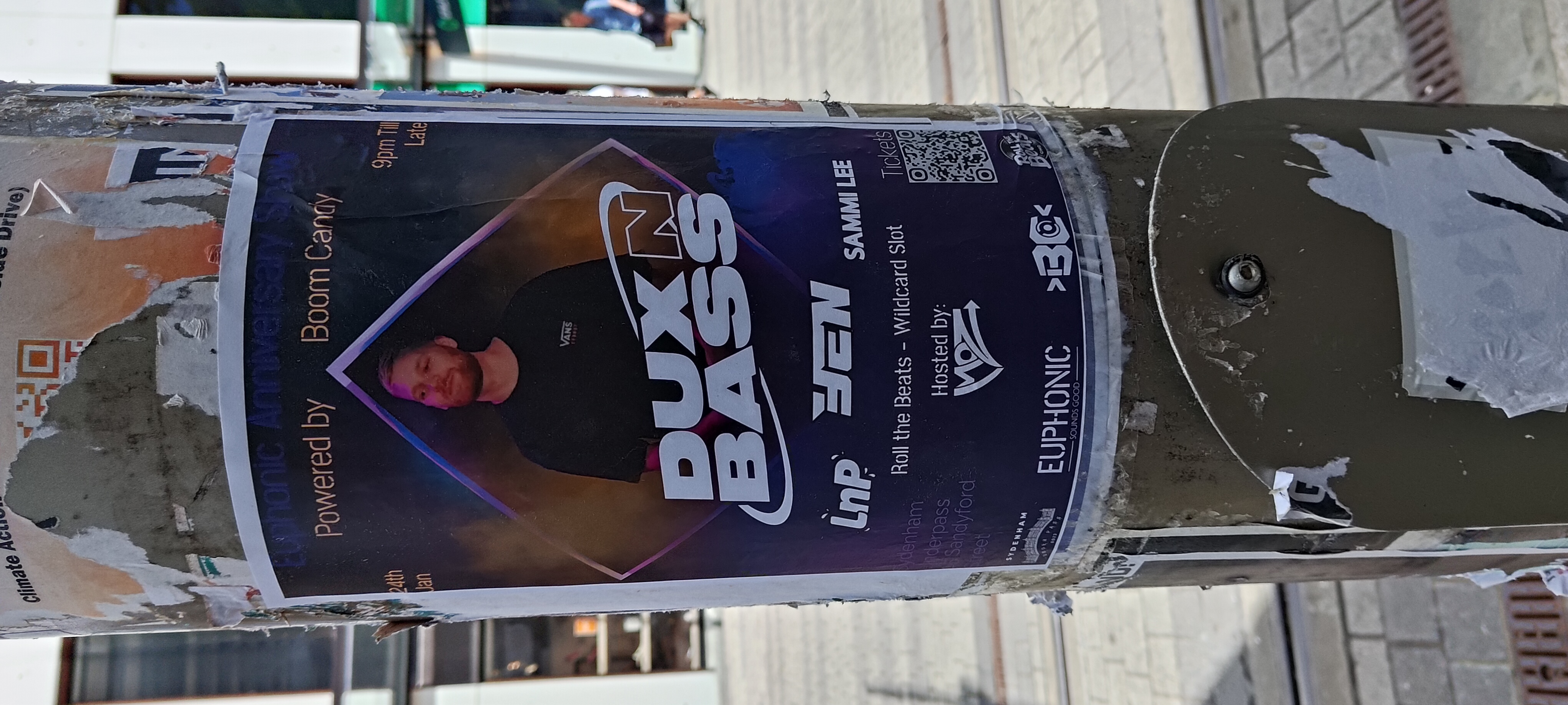 Dux Bass event poster with custom QR code on street pole
